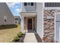 Inviting front porch with stone accents and a charming entrance, enhancing the curb appeal of this lovely home at 729 Little Patch St, Zebulon, NC 27597