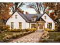 Charming white brick home with a welcoming front entrance and well-manicured landscaping at 7401 Ray Rd, Raleigh, NC 27613