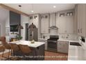 Modern kitchen with stainless steel appliances, a large island, and stylish pendant lighting at 7401 Ray Rd, Raleigh, NC 27613