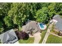 Aerial view of a home with a swimming pool and lush greenery at 7508 Venture Ct, Raleigh, NC 27615