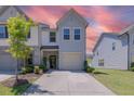 Charming two-story home with a well-manicured lawn and attached garage in a residential neighborhood at 79 Hawkstone Dr, Clayton, NC 27527