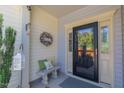Inviting front porch with charming decor, a stone bench, and a well-maintained entrance at 79 Hawkstone Dr, Clayton, NC 27527