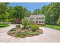 Beautiful landscaped circular driveway with mature plantings surrounding this traditional two story home at 800 Oxbow Crossing Rd, Chapel Hill, NC 27516