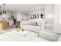 Bright living room with comfortable white sofa, stylish coffee table, and contemporary decor at 803 Fireship Rd, Fuquay Varina, NC 27526