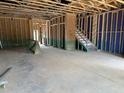 Unfinished basement features a staircase to a blank canvas for customization and versatile use at 805 Fireship Rd, Fuquay Varina, NC 27526