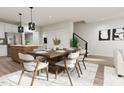 Open-concept dining room with modern table set and elegant decor, perfect for entertaining guests at 805 Fireship Rd, Fuquay Varina, NC 27526