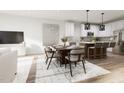 Inviting dining area features stylish furnishings and seamlessly connects to the contemporary kitchen at 805 Fireship Rd, Fuquay Varina, NC 27526