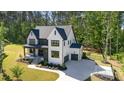 A charming two-story home boasts a side-entry garage, complementing its manicured lawn and landscaping at 904 Harrison Ridge Rd, Wake Forest, NC 27587
