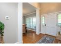 Welcoming entryway with hardwood floors, white columns, and natural light at 945 Jones Wynd, Wake Forest, NC 27587
