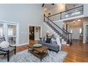 Comfortable living room featuring hardwood floors, a staircase and neutral decor at 945 Jones Wynd, Wake Forest, NC 27587