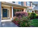 Inviting front entrance with a blue door, classic wreath, and vibrant landscaping, creating a warm and welcoming atmosphere at 9508 Vira Dr, Raleigh, NC 27617