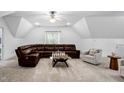 Spacious bonus room with comfortable seating, fan, and carpet at 1006 Trumpet Vine Ct, Wendell, NC 27591