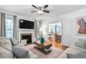 Inviting living room with a fireplace, plush seating, and view into dining area at 1006 Trumpet Vine Ct, Wendell, NC 27591