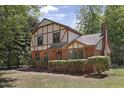 Beautiful Tudor-style home with a well-maintained lawn and mature trees at 101 Atchison St, Garner, NC 27529
