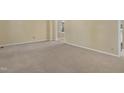 Neutral living room with fresh carpet and well-lit by natural light at 101 Atchison St, Garner, NC 27529
