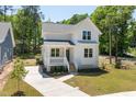 Beautiful two-story home with white siding, well-manicured lawn, and concrete driveway at 1013 Forrestal Pl, Durham, NC 27707