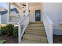 Close-up of front porch stairs, showing white railings and a green front door at 1013 Forrestal Pl, Durham, NC 27707