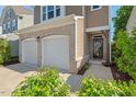 Close-up of home exterior with brick-accented garage and inviting front entryway at 1021 Sweet Cream Ct, Durham, NC 27703