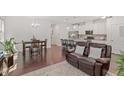 Open-concept living room and kitchen featuring modern finishes and hardwood flooring throughout the space at 1041 Cotulla Dr, Morrisville, NC 27560