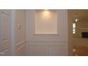 Entryway with wainscoting detail with view into the living room at 10461 Dapping Dr, Raleigh, NC 27614