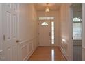 Bright foyer with hardwood floors, wainscoting, and decorative glass door at 10461 Dapping Dr, Raleigh, NC 27614