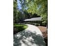 Long driveway leading to a charming home surrounded by trees at 10505 Winding Wood Trail Trl, Raleigh, NC 27613