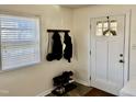 Bright entryway with natural light, coat rack, shoe rack, and a white door at 106 Eugene St, Carrboro, NC 27510