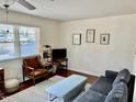 Cozy living room with hardwood floors, sofa, chair, and natural lighting at 106 Eugene St, Carrboro, NC 27510