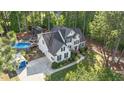 Aerial view of a two-story home with in-ground pool, deck, and well-maintained landscaping at 106 Wolverton Dr, Clayton, NC 27527