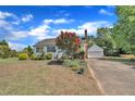 Lovely home with a detached garage and long driveway, complemented by colorful landscaping at 1112 Turner Farms Rd, Garner, NC 27529