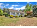 Beautiful front yard featuring a well-maintained lawn and mature trees surrounding the property at 1112 Turner Farms Rd, Garner, NC 27529