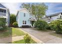 Charming two-story home with a well-maintained front yard and a concrete driveway at 117 Idlewild Ave, Raleigh, NC 27601