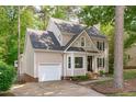 Attractive home with a welcoming facade, including an attached garage and well-manicured landscaping at 120 Avent Pines Ln, Holly Springs, NC 27540
