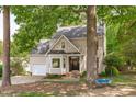 Charming home exterior featuring a well-maintained lawn and mature trees that add character and curb appeal at 120 Avent Pines Ln, Holly Springs, NC 27540