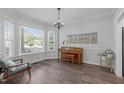 Bright living area with large windows and hardwood floors, perfect for relaxing or entertaining guests at 120 Avent Pines Ln, Holly Springs, NC 27540