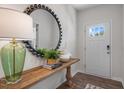 Welcoming entryway with a decorative mirror, console table with decor, and a view of the front door at 1205 Pavo Path, Wendell, NC 27591