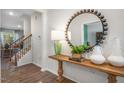 Inviting entryway featuring hardwood floors, staircase, accent table, modern decor, and attractive lighting at 1205 Pavo Path, Wendell, NC 27591