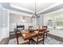 Formal dining room featuring elegant chandelier, wood table, and beautiful rug, perfect for entertaining at 121 Woodstaff Ave, Wake Forest, NC 27587