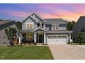 Charming two-story home with a well-manicured lawn, beautiful landscaping and a two car garage at 121 Woodstaff Ave, Wake Forest, NC 27587