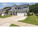 Charming two-story home with a two car garage, lovely landscaping, and a well-maintained lawn at 121 Woodstaff Ave, Wake Forest, NC 27587