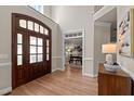 Grand foyer with hardwood floors, a two-story ceiling, and an open view into the office at 12508 Angel Falls Rd, Raleigh, NC 27614