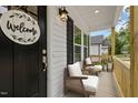 Inviting front porch with comfortable seating, stylish decor, and a welcoming atmosphere at 1303 Whitsett St, Burlington, NC 27217