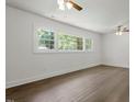 Bright bedroom featuring hardwood floors, neutral paint and a large window at 1314 Hudson Ave, Durham, NC 27705