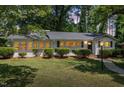 Exterior view of a charming single story home featuring a well-manicured lawn and welcoming entrance at 1314 Hudson Ave, Durham, NC 27705