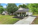 Inviting home featuring a lush green lawn and convenient concrete driveway at 1349 Crabtree Blvd, Raleigh, NC 27610