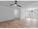 Bright living room with vinyl floors, ceiling fan and fresh white paint at 1349 Crabtree Blvd, Raleigh, NC 27610