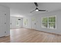 Open living room with vinyl floors, ceiling fan, and plenty of natural light at 1349 Crabtree Blvd, Raleigh, NC 27610