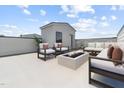 Relaxing rooftop terrace with comfortable seating around a modern fire pit feature and great view at 138 North White St # 200, Wake Forest, NC 27587