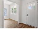 Bright entryway with hardwood floors and a white front door with sidelight windows at 1408 South St, Durham, NC 27707