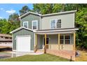 Beautiful craftsman style home with covered front porch, garage, and neat landscaping at 1408 South St, Durham, NC 27707